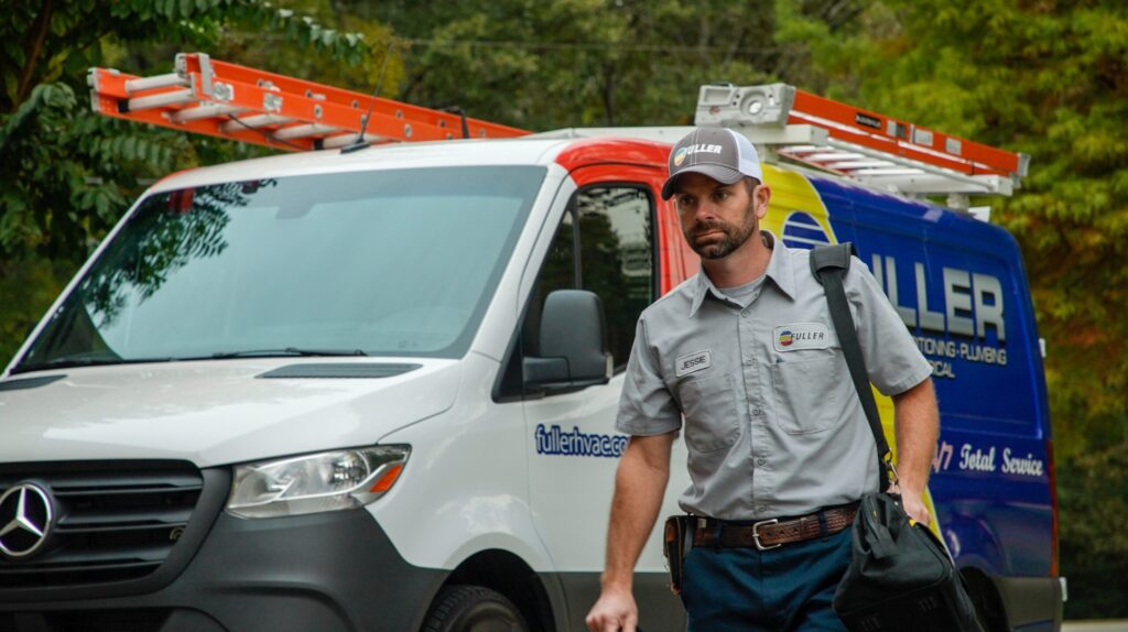 Fuller HVAC professional walking near service van in North Alabama