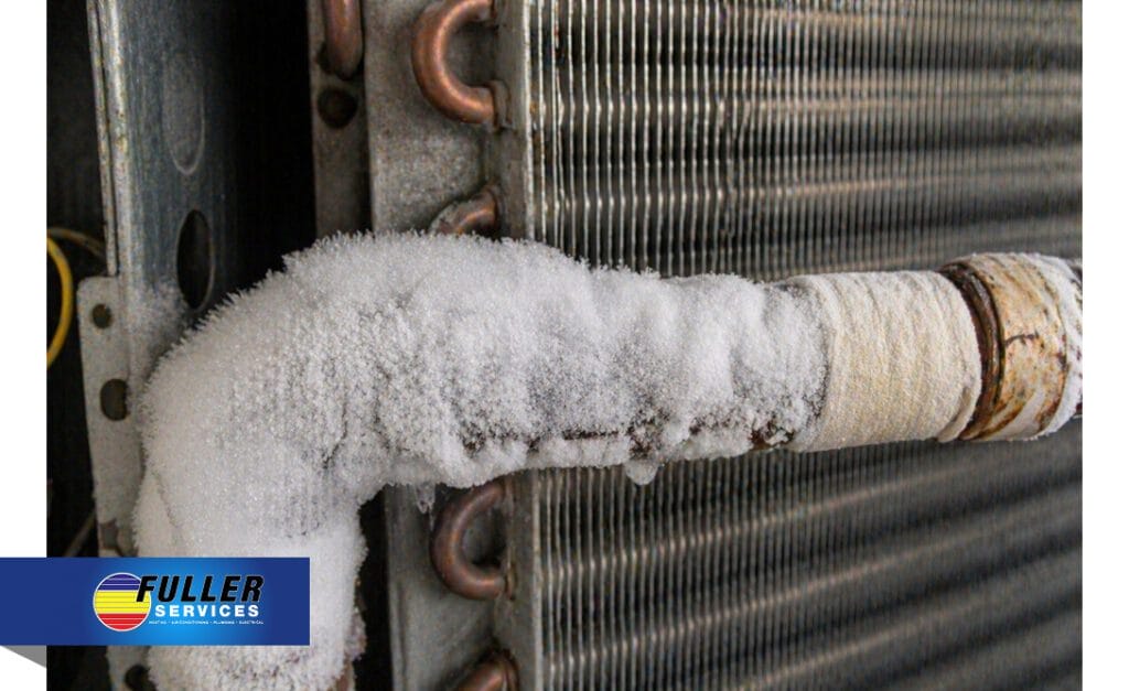 Close-up of an HVAC line covered in heavy ice buildup next to the evaporator coil.