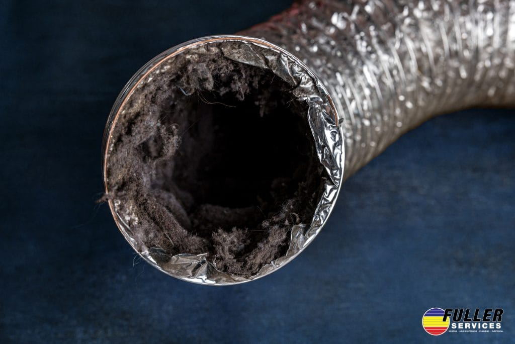 Flexible dryer vent hose clogged with heavy lint and debris buildup.